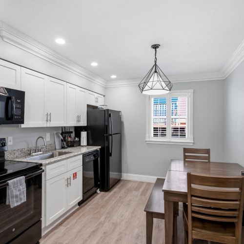 Fully equipped kitchen w/ modern appliances & a dining area to gather.