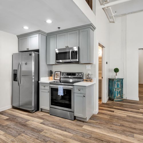 Gray shaker kitchen with full-size fridge
