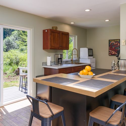 Gather around the spacious kitchen island with seating and easy access to the outdoor deck.