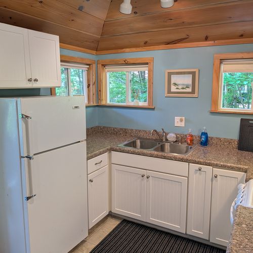 KITCHEN: The accommodating kitchen suited with a fridge, an oven, a toaster, a coffeemaker, and other kitchen essentials