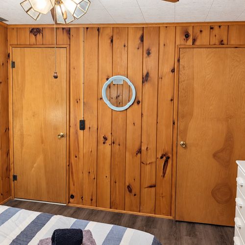 BEDROOM #2:   Features a queen-size bed, nightstands, lamp, dresser, closet, and chair.