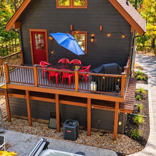 OVERVIEW:  The gorgeous backyard deck with outdoor dining furniture and a propane grill.
