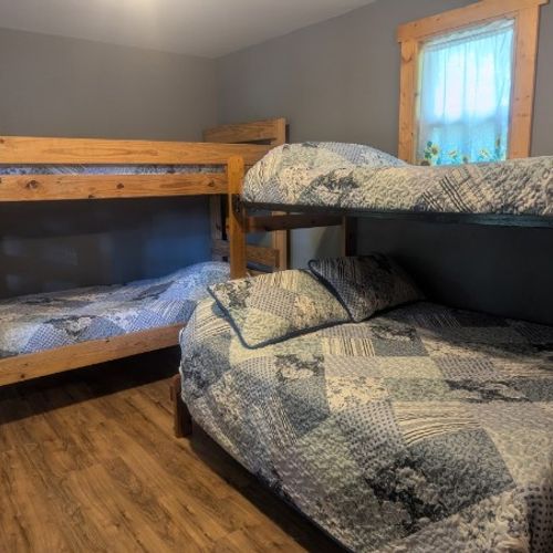MAIN ROOM:  The main room, which features 6 beds (5 twins and 1 double), a small dining table, and a small sink / kitchenette.