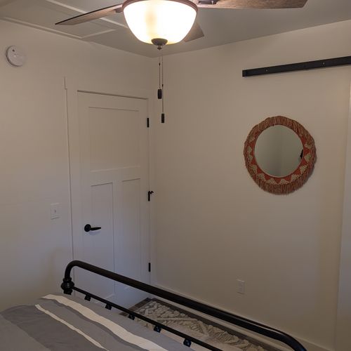 BEDROOM #2 (SECOND FLOOR):  Features a queen-size bed, nightstand, lamp, dresser, mirror, closet, and ceiling fan.