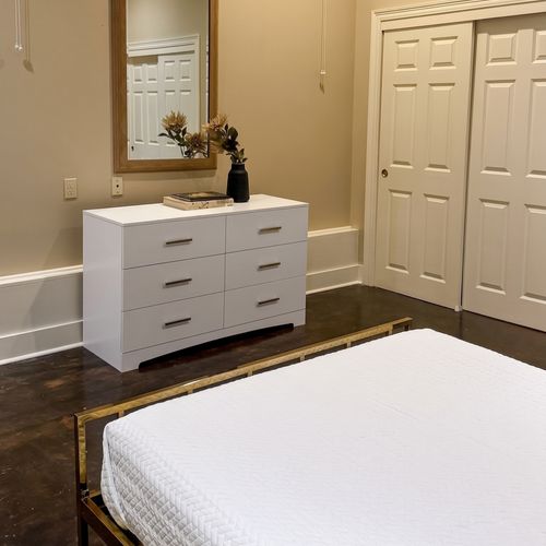 Bedroom with dresser and convenient storage space
