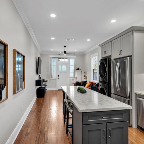Chat over the island while dinner cooks in this open-concept kitchen w/ in-unit washer & dryer