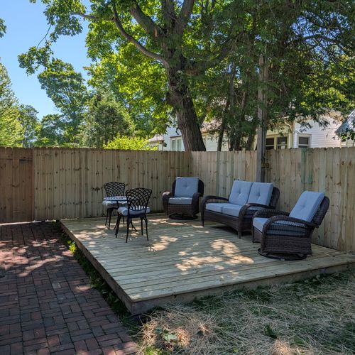 EXTERIOR: The cute fenced-in backyard with plenty of seating. Fun and relaxing times found here!