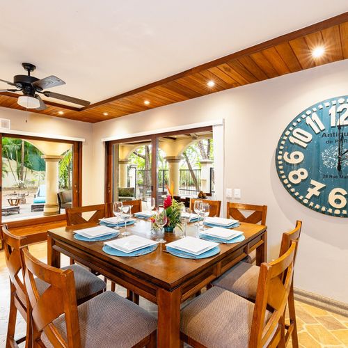 Open-concept great room - full kitchen, dining for 6, smart-TV lounge, all under wood plank ceilings.