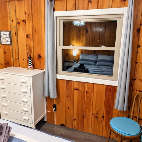 BEDROOM #2:   Features a queen-size bed, nightstands, lamp, dresser, closet, and chair.