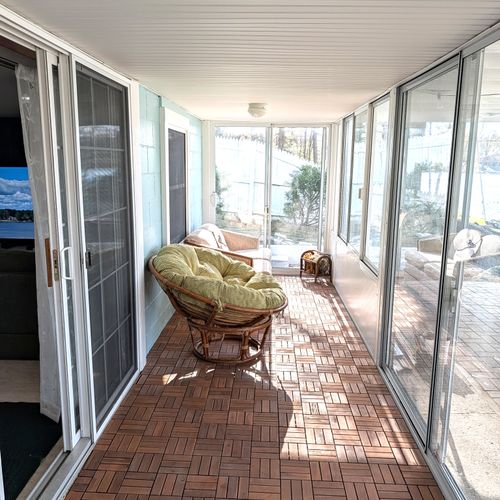 SUN ROOM (LOWER LEVEL):  The home has a beautiful sun room outside of the entertainment area on the lower level.  Features gorgeous views of Bass Lake!