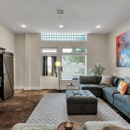 Spacious living with tall windows and natural light