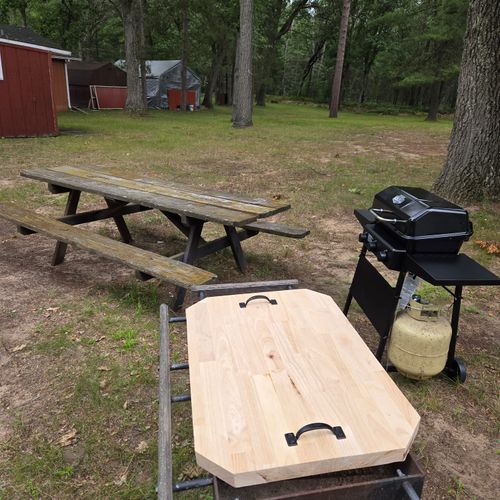 EXTERIOR:  The backyard propane grill and picnic table.
