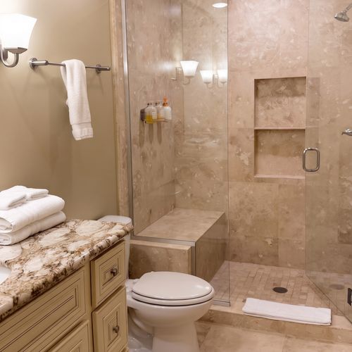 Bathroom w/ granite vanity, sink & glass shower