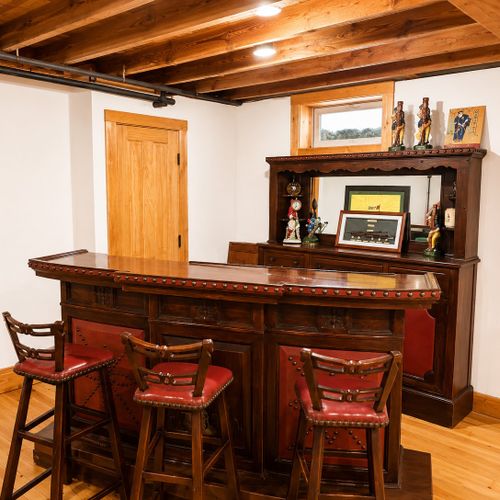 BASEMENT:  The home has a partially finished basement with a pool table, card table, bar, bedroom, and a full bathroom.