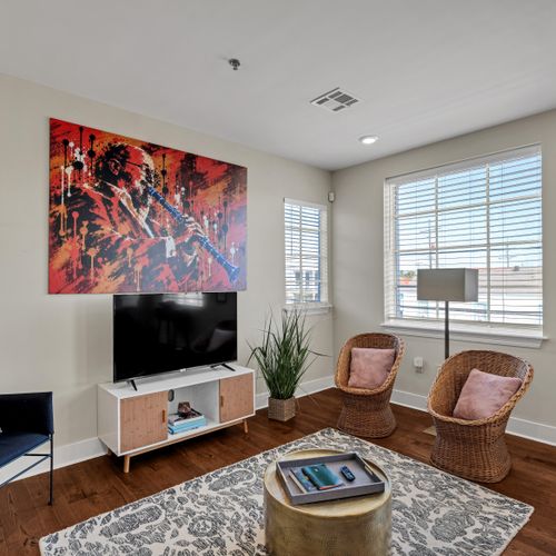 Cozy lounge with accent chairs and a Smart TV