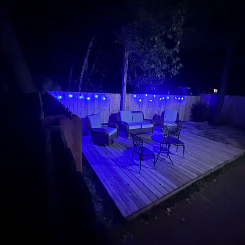 EXTERIOR: The cute fenced-in backyard at night.
