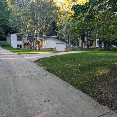 EXTERIOR:  The large front yard and private driveway