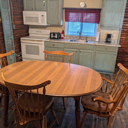 DINING AREA:  There is a cute dining table with seating for 4 adults in the middle of the kitchen.