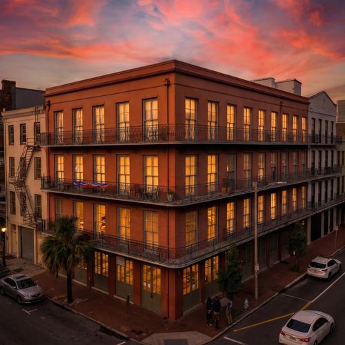 Iconic wrought-iron balconies on a historic corner building straight out of a postcard.
