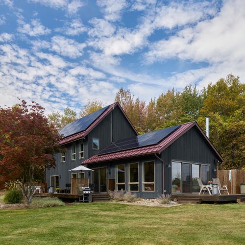 Looking towards the main house and hot tub deck. Oversized windows and sliding glass doors create beautiful views on the interior and fill the space with light.