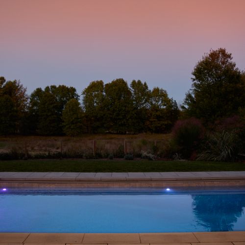 Thoughtful lighting invites guests to enjoy swimming into the evening.