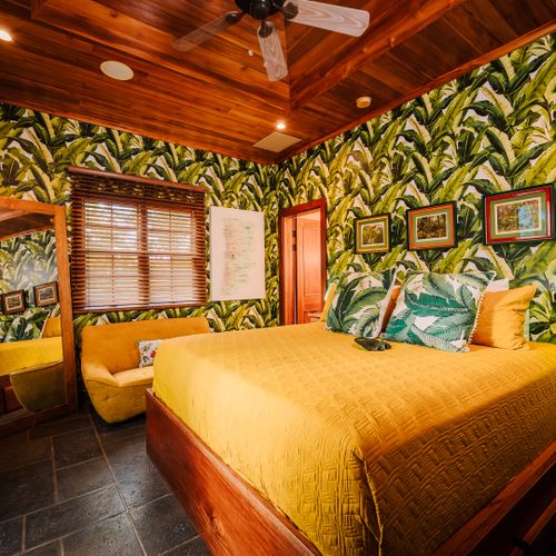 Luxury master suite with king size bed, elegant coastal decor, and natural light at a Playa Langosta vacation rental in Tamarindo, Costa Rica. Spacious and relaxing retreat ideal for family vacations, extended stays, and tropical beach living.