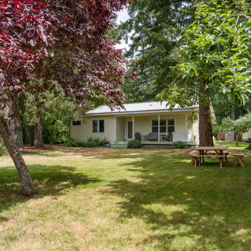 Enjoy a large, peaceful yard surrounded by mature trees, offering plenty of space to relax, picnic, or simply soak in the beauty of nature.