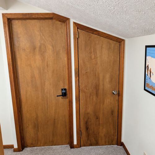 BEDROOM #2 (FIRST FLOOR):  Features a twin-on-twin bunk bed, nightstand, closet, dresser, and mirror.