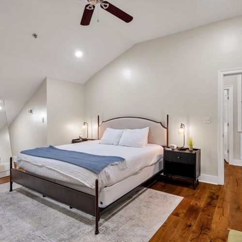 Iron bed under a vaulted ceiling