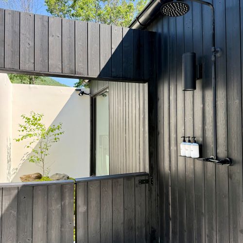 Refresh beneath the open sky in the sleek private outdoor shower.