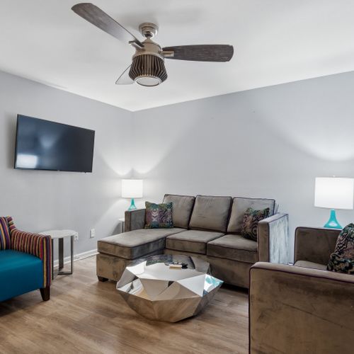 Airy living area w/ plush sofa & flatscreen TV to kick back after a long day.