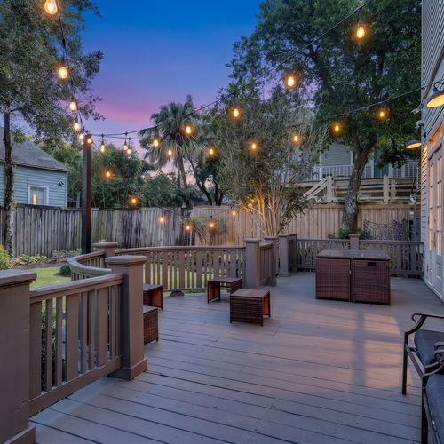 Spacious deck w/ string lights & lounge seating — perfect for evening gatherings under the trees.