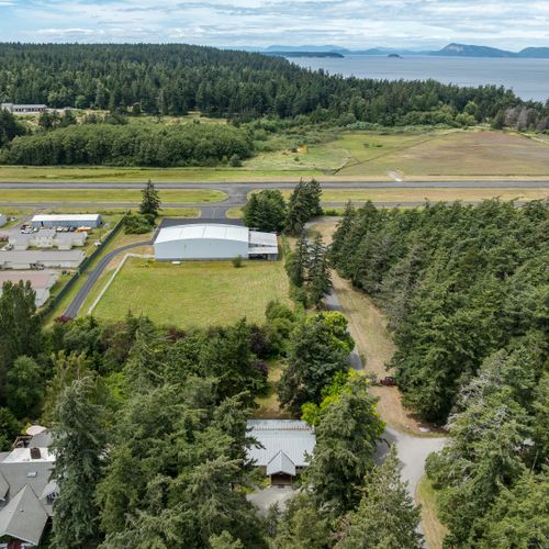 A peaceful retreat surrounded by towering evergreens, with the marina, shoreline, and island attractions just a short drive away.