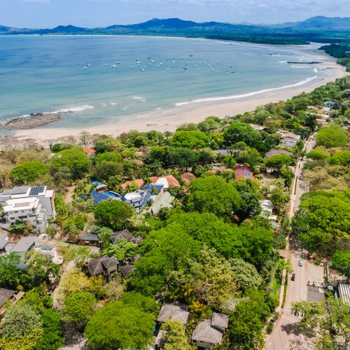 Aerial view of gated community near Langosta Beach Club. Access included with your stay at this Langosta rental near Tamarindo. Tropical landscaping, private villas, and exclusive beach club amenities for an elevated coastal escape.