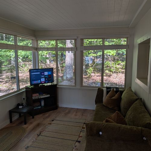 SUNROOM:  The sunroom has a sofa along with a streaming television.