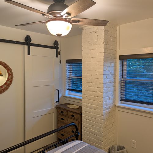 BEDROOM #2 (SECOND FLOOR):  Features a queen-size bed, nightstand, lamp, dresser, mirror, closet, and ceiling fan.