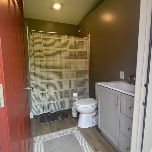 BATHROOM #2:  Full bathroom with a walk-in shower, toilet, sink, vanity, and mirror.