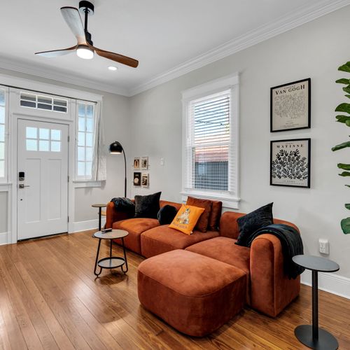 Sink into the cozy sectional surrounded by a curated gallery wall & sunny front windows