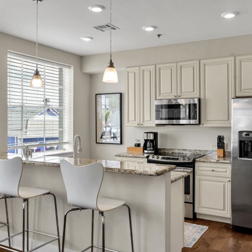 Sunny kitchen with pendant lighting and window views