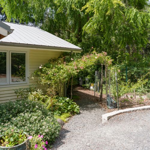 Beautiful landscaped gardens and a charming garden path create a peaceful setting, adding to the cottage's private and relaxing atmosphere.