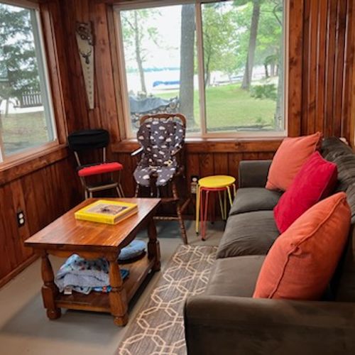 SUNROOM:  The home has a lovely sunroom with lots of seating and a great view of Van Etten Lake.
