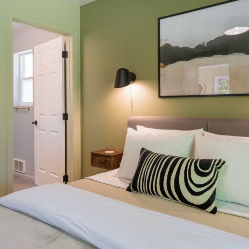 Rest comfortably in this serene bedroom with direct access to the adjoining bathroom.
