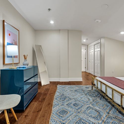 Teal dresser and patterned rug for extra charm