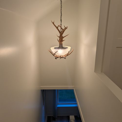 STAIRS:  Consistent with the deer theme throughout the house, there's a beautiful deer antler chandelier above the stiars.