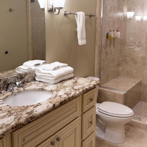 Bathroom w/ granite vanity & fresh linens