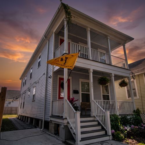 Charming New Orleans-style home w/ a classic double balcony & colorful curb appeal.