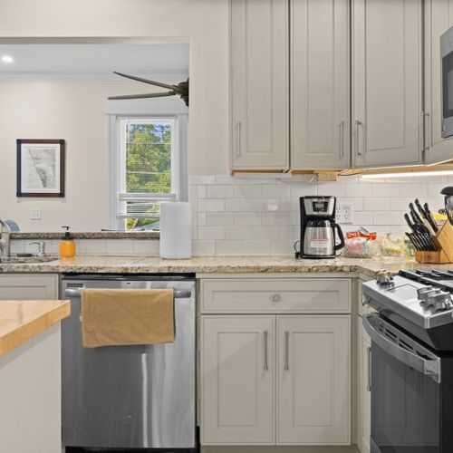 KITCHEN - HOUSE: The house has a newly-renovated kitchen with a large kitchen island and all appliances, including a dishwasher. There is also a good supply of cooking and dining utensils provided