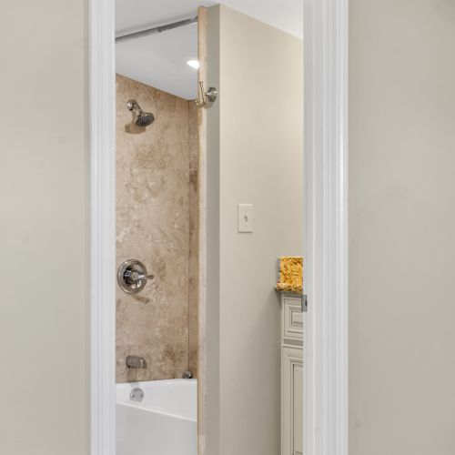 Stone-tiled shower with rainfall-style comfort