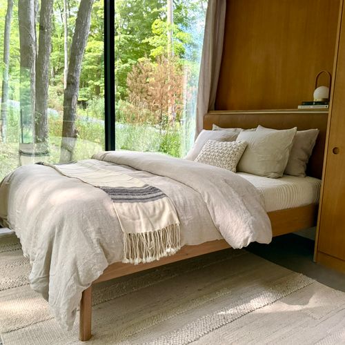 Wake up immersed in nature with panoramic forest views from your bed.