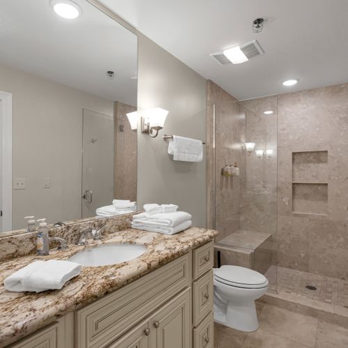 Glass shower and towels stacked and ready
